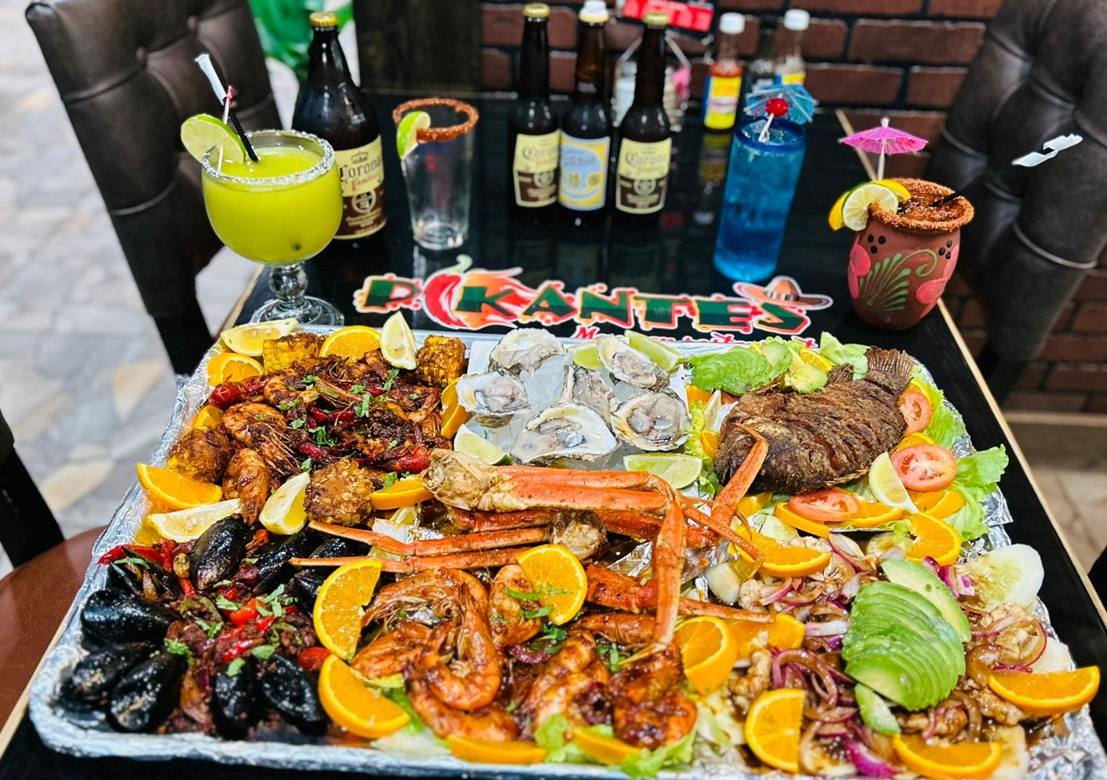Mariscada seafood platter with crab legs, oysters, mussels, shrimp and fried fish served with Mexican beers